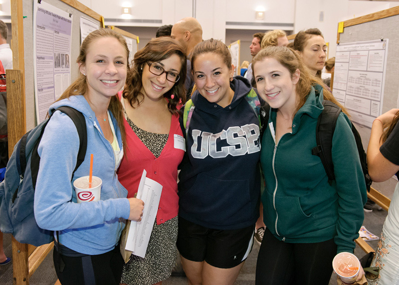 Four girls posing at poster sessions